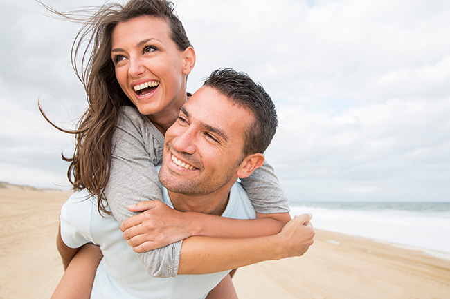 portrait of living young couple at the beach happy couple on beach